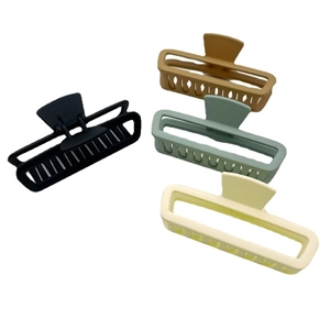 Set of four matte rectangle hair claws in black, brown, green, and beige on white background