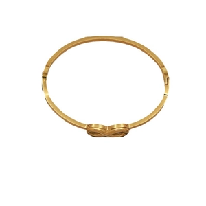 Minimalist gold-plated stainless steel infinity bow bangle for women on white background