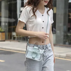 Light blue transparent mini jelly crossbody bag with top handle and matching inner pouch