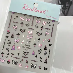 Detail view of punk bow nail stickers with skulls and metallic gothic elements