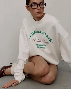 Detail of white crewneck sweatshirt featuring green and burgundy Florida State vintage print