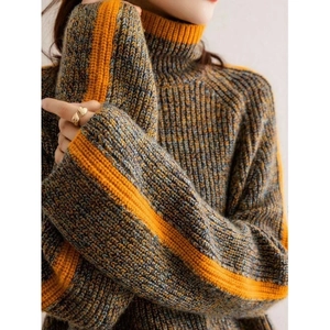 Detailed close-up of thick high-neck knit sweater featuring grey and yellow stripes