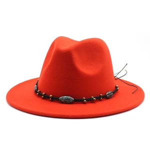 Detail of red wool fedora with black braided band and turquoise vintage bead accents