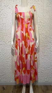 Detail of vibrant floral print dress with tiered skirt and adjustable tie straps