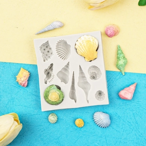Detail of seashell shaped silicone cake mold for chocolate fondant on vibrant background