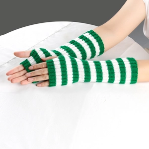 Detail of green and white striped long knitted fingerless gloves worn on arms