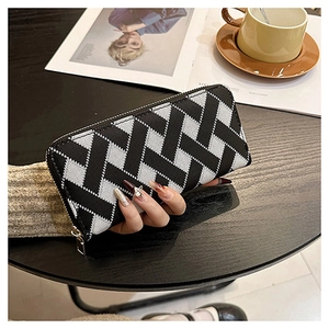 Detail of the woven geometric pattern and zipper closure on this long knit wallet