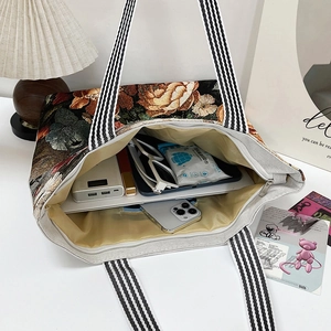 Ethnic 3D floral embroidered canvas tote bag showing spacious interior with daily essentials