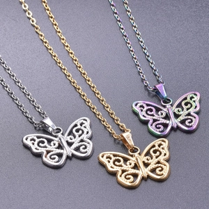 Detailed macro view of three 18k plated butterfly pendants in silver, gold, and purple