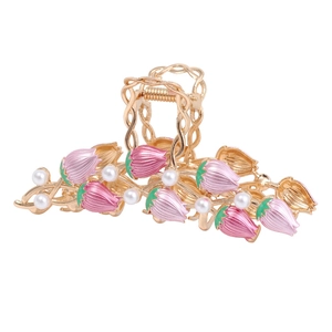 Elegant gold alloy shark hair claw with pink tulip flowers and pearls on white background
