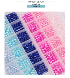Close-up of 6mm ABS pearl beads in a 24-grid organizer box for DIY jewelry making
