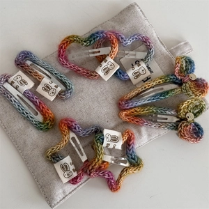 Handmade rainbow crochet hair clip set with heart, star, and bow designs for girls