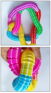 Detail showing hand stretching colorful striped pop tubes for sensory tactile play