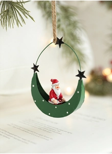 Detail of Santa Claus sitting in a green moon metal ornament with rustic hanging rope