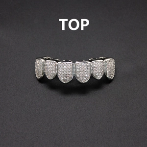 Macro view of iced out silver grillz for top teeth with micro paved cubic zirconia