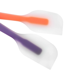 Orange and purple silicone spatulas with translucent heads for baking and mixing cakes