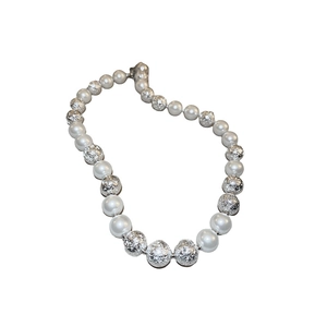 Elegant silver textured metal beads and white pearls necklace displayed on white background