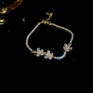 Detailed macro view of gold-plated flower bracelet with sparkling zircon stones