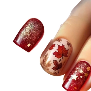 Autumn press-on nails featuring red maple leaves and gold stars with glitter finish