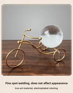 Detail of golden metal tricycle craft with clear crystal ball home decoration
