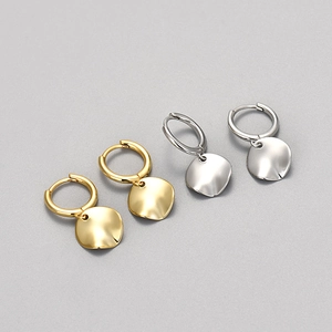 Minimalist irregular wave disc earrings in gold and silver finish with metallic luster