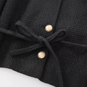 Women's black tweed jacket with luxury gold buttons and a matching waist belt detail