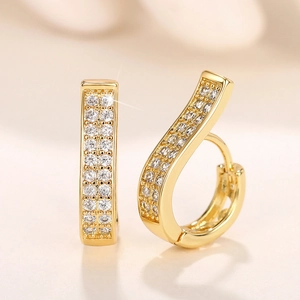 Macro shot of gold-plated hoop earrings with double-row micro-pave zirconia detail