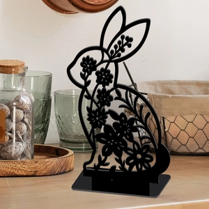 Detailed view of hollow floral cut rabbit ornament with natural wooden base for Easter decor