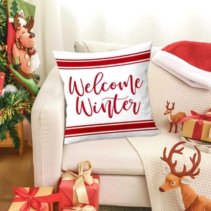 Christmas cushion cover with Welcome Winter print on a cozy sofa with holiday decor