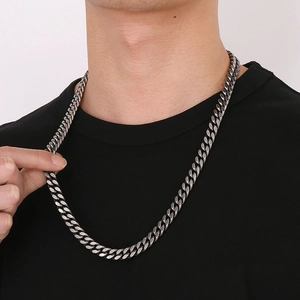 Silver vintage cuban link stainless steel necklace worn by male model on black t-shirt