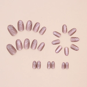 Elegant rose gold cat-eye press-on nails with white flower patterns and glitter finish