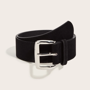 Vintage black suede leather wide belt with polished silver buckle on cream background