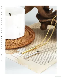 Minimalist gold and silver cylinder pendant necklaces on O-chain in a vintage setting