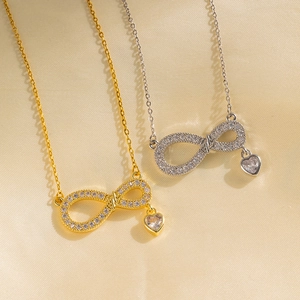 Elegant gold and silver infinity heart pendant necklaces with shimmering zircon crystals