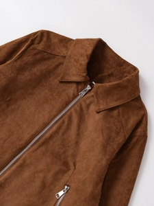 Detailed close-up of brown faux suede jacket collar with silver zipper closure