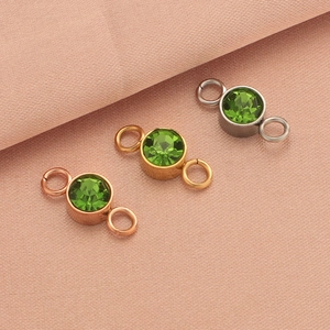 Detailed view of stainless steel birthstone connector charms in rose gold, gold, and silver