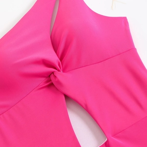 Detailed view of the rose red swimsuit featuring a stylish knot design and geometric cut-out