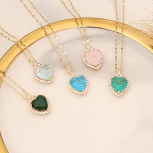 Elegant gold heart necklaces with colorful gemstone pendants in five vibrant shades