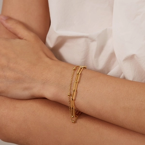 Close-up of double-layer gold stainless steel bracelet with paperclip and bead chain design