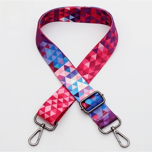 Close-up of colorful geometric woven bag strap with gunmetal lobster claw clasps