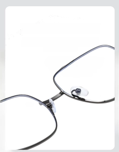 Detail shot of adjustable clear silicone nose pads on grey metal glasses frame