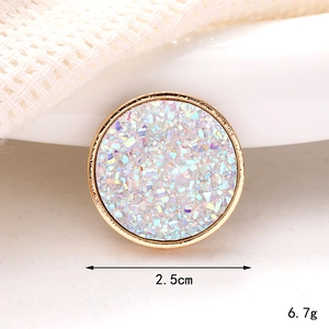 Macro shot of a 2.5cm gold-framed round charm with iridescent stone inlay and measurements