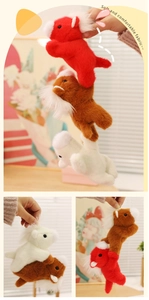 Close-up of soft plush magnetic pony dolls in red, brown, and white colors