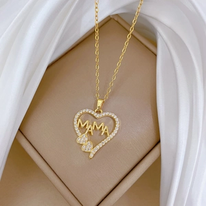Elegant gold titanium necklace with MOM heart pendant and sparkling zircons on beige box