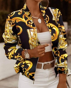 Detail of baroque gold leaf print on women's long sleeve zip jacket with black gold theme