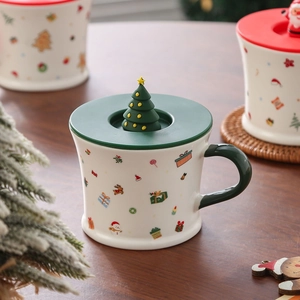 Detailed view of Santa ceramic mug featuring green lid with 3D Christmas tree topper