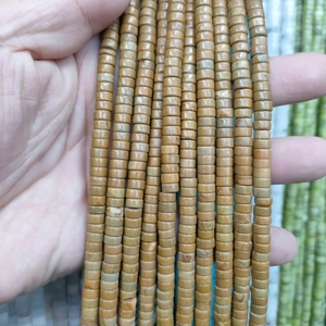 Macro view of cylindrical tiger eye spacer beads with natural earthy stone textures