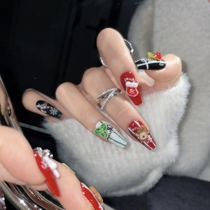 Handmade Christmas press-on nails with 3D reindeer and Santa hat designs on long coffin nails