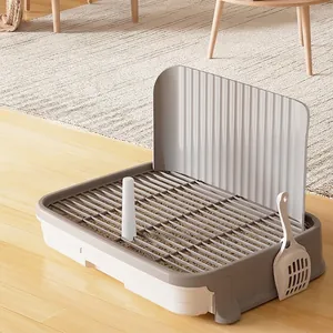 Large dog training toilet with high splash guard and cleaning shovel in grey and white