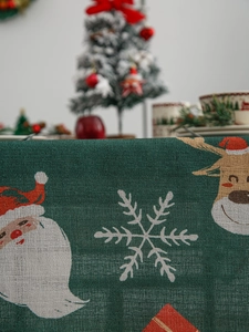 Close-up of Nordic Christmas tablecloth texture with woven Santa and reindeer patterns